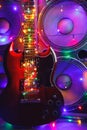 Abstract guitar with festive Christmas lights and music speakers