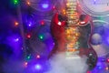 Abstract guitar with festive Christmas lights and music speakers in smoke