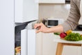 Abstract hand a young man is opening a refrigerator door Royalty Free Stock Photo