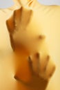 Abstract hands, human arm inside yellow fabric