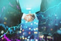 abstract handshake and forex chart on bokeh night city backdrop. Financial growth and partnership concept. Double exposure Royalty Free Stock Photo