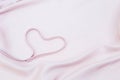 Abstract heart shape on soft pink fabric texture background Royalty Free Stock Photo