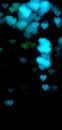 Abstract heart-shaped bokeh in blue colors on black background.  Bokeh lighting to decorate at night  blur wallpaper valentines Royalty Free Stock Photo