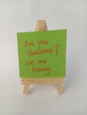 Abstract we are hiring are you awesome sign on a wood easel on a white background