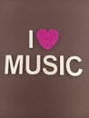 Abstract I love music with heart shape instead of the word love on a brown background Royalty Free Stock Photo