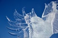 Abstract ice sculpture eagle spread its wings against the blue sky. Royalty Free Stock Photo
