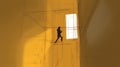 Abstract illustration of a figure walking in a bright yellow corridor with a window and shadows Royalty Free Stock Photo