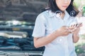 The abstract image of business man point to the hologram on his smartphone and blurred car engine room is backdrop. the concept of Royalty Free Stock Photo