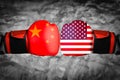 The abstract image of the businessman wearing a boxing mitts overlay with cityscape and Chinese,USA. flag image. the concept of fi Royalty Free Stock Photo