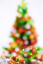 Abstract image of a colorful Christmas tree and lights of garlands on a white background. Royalty Free Stock Photo