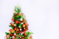 Abstract image of a colorful Christmas tree and lights of garlands on a white background. Royalty Free Stock Photo