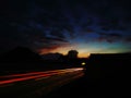 Abstract image with colorful stripes in front of a dramatic sky