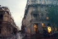 Abstract image of drops of rain on the glass, blurred city street on the background. Rainy day Royalty Free Stock Photo