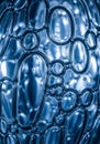 Abstract image featuring a close-up of transparent blue bubbles, interlocking in various oval and Royalty Free Stock Photo