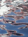 abstract image formed by reflection of a boat on river water