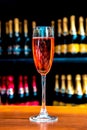 Abstract image of a glass with champagne on the background of bottles celebrations, anniversaries, wine - concept Royalty Free Stock Photo