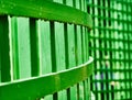 Abstract image of a green curved fence on which raindrops hang