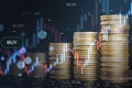 Abstract image of growing coin stacks and candlestick forex chart on blurry wallpaper. Trade, money and financial growth concept. Royalty Free Stock Photo