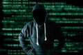 The abstract image of the hacker standing and the binary code image is backdrop. the concept of cyber attack, virus, malware, ille