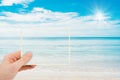 Abstract image of Hand holding a picture of beautiful seascape view in summer time.