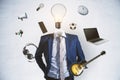 Abstract image of headless businessman with idea head, laptop, guitar and other items flying around on white wall background.