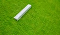 Abstract image of an inclined grass surface on an embankment with a diagonal concrete beam