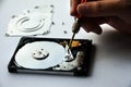 The abstract image of inside of hard disk drive with technician fixing using screw driver on white background. Concept Royalty Free Stock Photo