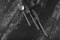 Abstract image of knife, spoon and fork on dark background Royalty Free Stock Photo