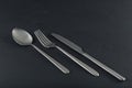 Abstract image of knife, spoon and fork on dark background Royalty Free Stock Photo