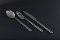 Abstract image of knife, spoon and fork on dark background Royalty Free Stock Photo