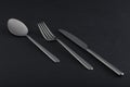 Abstract image of knife, spoon and fork on dark background Royalty Free Stock Photo