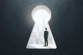 Abstract image of man standing in keyhole opening and looking into the distance on blurry city background. Vision, future and Royalty Free Stock Photo