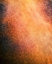 RED AND ORANGE PARTICLES SWIRLING IN TURBULENT AIR