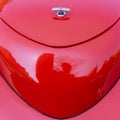 Abstract image of the red rounded end of an unidentifiable car