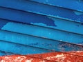 Abstract image of a ship hull in red and blue colors with peeling varnish