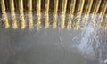 Abstract image with silver and gold brass surfaces, gun bullets line Royalty Free Stock Photo