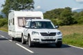 The abstract image of Skoda Yeti SUV car towing a caravan with extreme motion blur effect in Scottish landscape