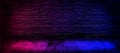 Studio dark room with lighting effect red and blue on black brick wall gradient background for interior decoration. Royalty Free Stock Photo