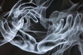 Abstract image of two hands in the form of ghostly smoke. Royalty Free Stock Photo