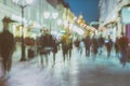 Abstract image of unrecognizable silhouettes of people walking in city street in evening, nightlife. Urban modern Royalty Free Stock Photo