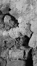 Abstract image of an very old wall, broken plaster with old, partly broken bricks inside, aged with long time. Royalty Free Stock Photo