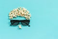 Abstract image of viewer, 3D glasses and popcorn on blue background. Concept cinema movie and entertainment Flat lay Top