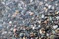 Abstract image of the water ripples over the stone pebbles in the Mediterranean Sea. Royalty Free Stock Photo