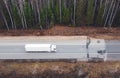 Abstract image of white truck of logisctic company with cargo and its big silhouette is driving on the asphalt road i Royalty Free Stock Photo