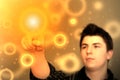 Abstract Image - Young Man Touching Glowing Orange Floating Spot