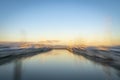 Abstract impressionist style Tauranga Marina boats and piers reflected in calm water at sunrise