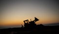 Abstract Industrial background with construction crane silhouette over amazing sunset sky. Mobile crane against the evening sky. Royalty Free Stock Photo