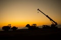 Abstract Industrial background with construction crane silhouette over amazing sunset sky. Mobile crane against the evening sky. Royalty Free Stock Photo