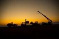 Abstract Industrial background with construction crane silhouette over amazing sunset sky. Mobile crane against the evening sky. Royalty Free Stock Photo