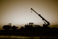 Abstract Industrial background with construction crane silhouette over amazing sunset sky. Mobile crane against the evening sky. Royalty Free Stock Photo